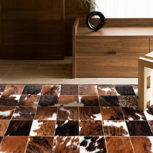 Luxury cowhide rug for modern living room interior — natural leather patchwork design.