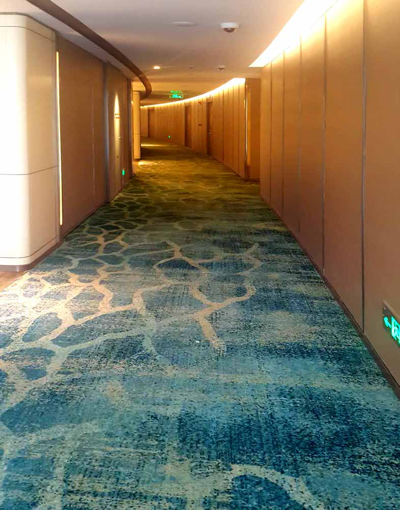 Axminster carpet installed in a luxury hotel corridor — custom pattern and seamless alignment
