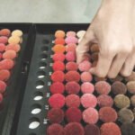 Designer selecting yarn colors for custom hand tufted rug production